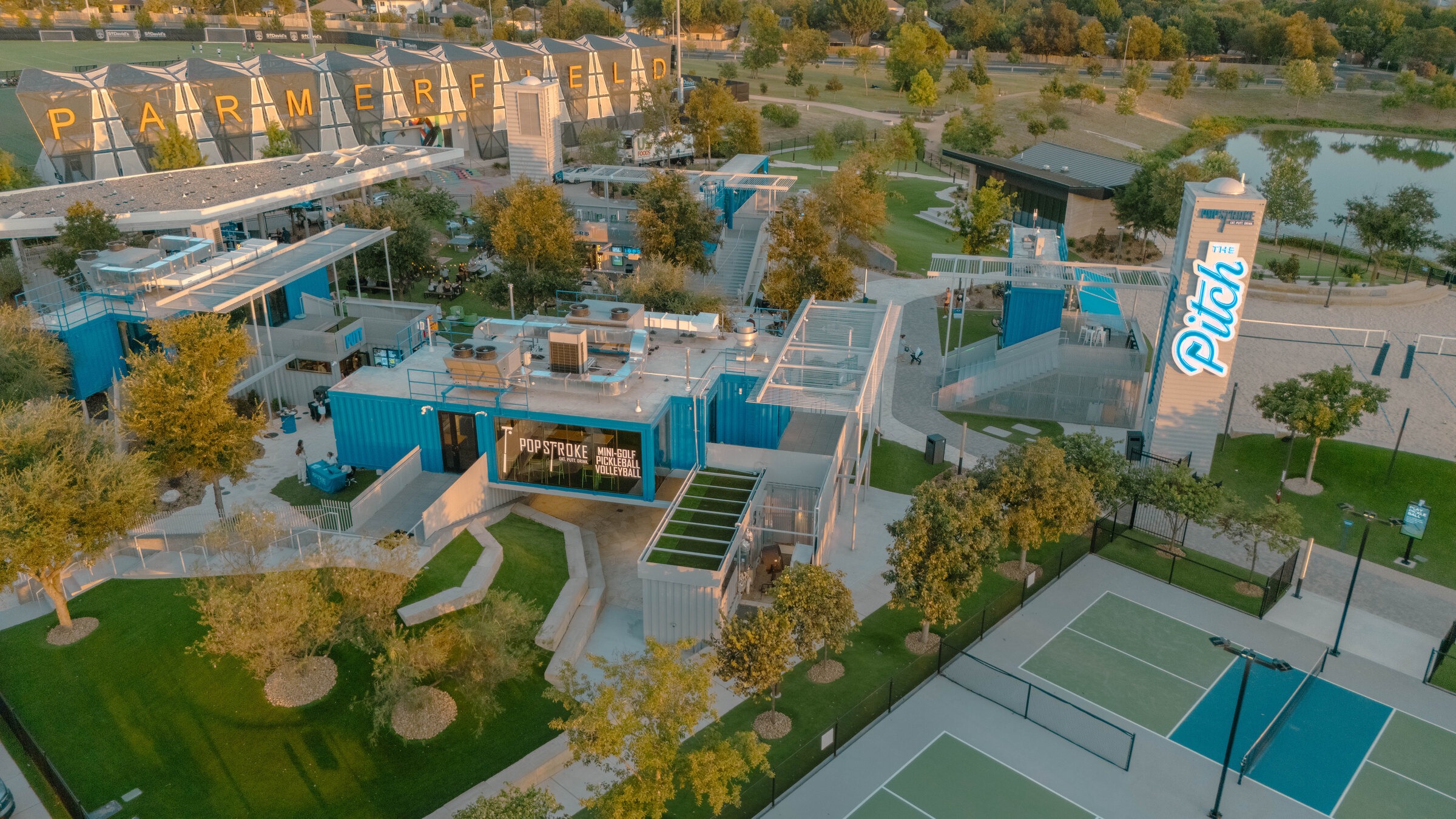 Aerial view of PopStroke Austin at The Pitch, with the pickleball courts in front